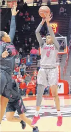  ?? JIM THOMPSON/JOURNAL ?? UNM’s Jayla Everett, right, launches a 3-point shot over Nevada’s Emma Torbeert on Saturday. Everett scored a game-high 24 points.