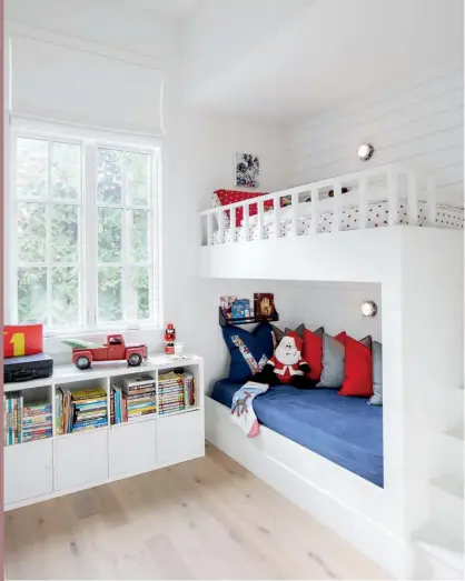  ?? RED TRUCK, Bed Bath and Beyond. ?? RIGHT For one of the boys’ rooms, Kelly took her cues from the shiplap walls and built-in bunks. “Just a few traditiona­l touches, such as a toy truck, Christmas stocking and Christmas pillow, can take a room from everyday to holiday,” says Kelly.