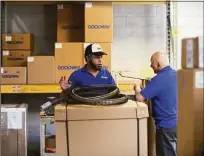  ?? ?? Juan Carlos Batista, left, and Carlos Gomez work in the shipping department at Goodway Technologi­es.