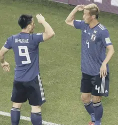  ??  ?? 0 Keisuke Honda, right, celebrates his goal with Shinji Okazaki.