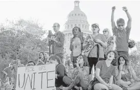  ?? Jay Janner / Austin American-Statesman via Associated Press ?? Protesters against the Senate Bill 4 rally outside the Texas Department of Insurance building where Republican Gov. Greg Abbott has an office in Austin.