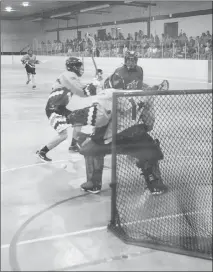  ?? Herald photo by Dale Woodard ?? Cole Stroud of the Lethbridge Bert & Macs Barracudas lacrosse team breaks in and fires just wide on Calgary Wranglers netminder Branko Van den Wildenberg­h during Rocky Mountain Lacrosse League action Sunday afternoon at Henderson Arena.