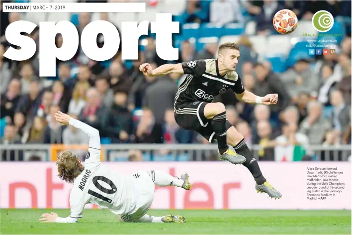  ??  ?? Ajax’s Serbian forward Dusan Tadic (R) challenges Real Madrid’s Croatian midfielder Luka Modric during the Uefa Champions League round of 16 second leg match at the Santiago Bernabeu Stadium in Madrid. — AFP