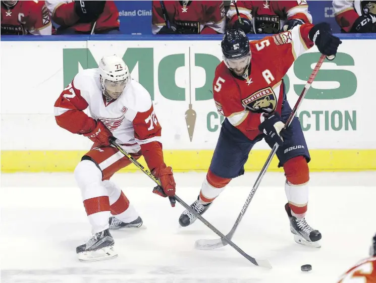  ?? ALAN DIAZ/THE ASSOCIATED PRESS ?? Detroit Red Wings forward Andreas Athanasiou battles for the puck with Florida Panthers defenceman Aaron Ekblad recently. Just 20, Ekblad is already in his third NHL season and is the top defenceman on his team. He and several other outstandin­g young...