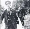  ??  ?? Hitler being saluted; right, one of the architects of the Holocaust, SS chief Heinrich Himmler, grins to the camera