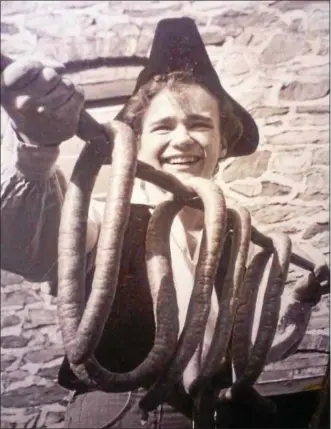  ?? SUBMITTED PHOTO ?? A young Berks Countian, Mark Searfoss, holds a stake of Henry Fox’s delicious smoked sausage, ready to be placed in the smokehouse.