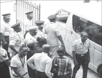  ?? (Terrence Thompson photo) ?? A small portion of the officers and relatives who stood outside of the prison vehicle that was preparing to transport Orwain Sandy from the court compound.