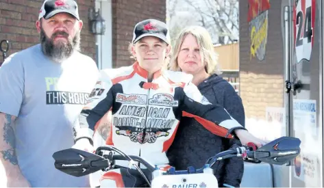  ?? DAVID CHERNISH/SPECIAL TO POSTMEDIA NETWORK ?? Motorcycle racer Hunter Bauer, 12, of Chippawa is backed by his biggest supporters, father Bob and mother Krista.