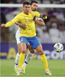  ?? Chris Whiteoak / The National ?? Al Nassr’s Cristiano Ronaldo under pressure from Khalid Al Hashemi of Al Nassr on Monday