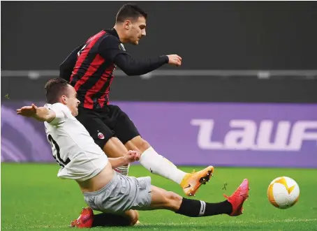  ?? AFP ?? AC Milan’s Portuguese defender Diogo Dalot, right, scores during the UEFA Europa League Group H match against Sparta Prague on Thursday.
