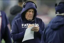  ?? THE ASSOCIATED PRESS ?? New England head coach Bill Belichick takes notes on the sideline during the Patriots’ wild-card playoff game against the Tennessee Titans in Foxborough, Mass., on Jan. 4, 2020.