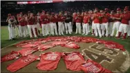  ?? MARCIO JOSE SANCHEZ - THE ASSOCIATED PRESS ?? Members of the Los Angeles Angels place their jerseys with No. 45 in honor of pitcher Tyler Skaggs on the mound after a combined no-hitter against the Seattle Mariners during a baseball game Friday, July 12, 2019, in Anaheim, Calif. The Angels won 13-0.