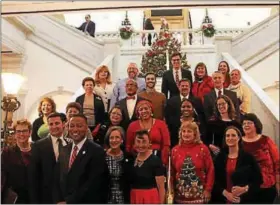  ?? PHOTO COURTESY OF MONTGOMERY COUNTY COMMISSION­ERS ?? The Montgomery County commission­ers pose with Courthouse Chorus on the grand staircase during annual holiday concert.