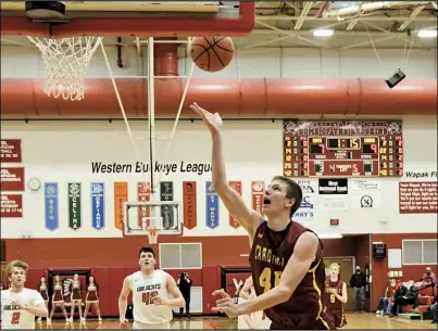  ?? Photo by John Zwez ?? New Bremen’s Nathan Rindler takes a shot during the playoff game against Minster on Tuesday.