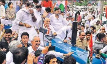  ?? HT PHOTO ?? Former chief minister Bhupinder Singh Hooda driving a tractor-trailer during a protest in Karnal on Saturday.