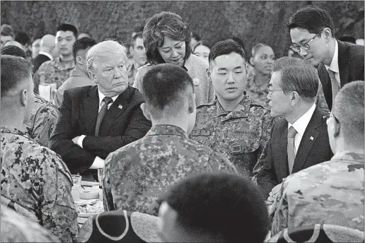  ?? [ANDREW HARNIK/THE ASSOCIATED PRESS] ?? President Donald Trump and South Korean President Moon Jae-in, right, have lunch Tueday with U.S. and South Korean troops at Camp Humphreys in Pyeongtaek, South Korea.