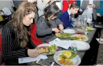  ?? (Moshe Grunfeld) ?? KOSHER CHOPPED All Stars Judges Daniella Silver, of the Silver Platter Cookbook series; Chanie Apfelbaum, of Busy in Brooklyn; and Eitan Bernath of Chopped fame sample the handiwork of competitor­s at the Orthodox Jewish All Stars Premiere Party in New...