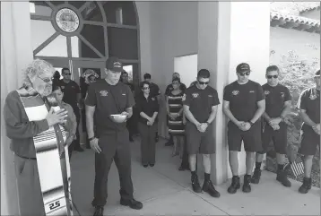  ?? LOANED PHOTO/SAN LUIS FIRE DEPARTMENT ?? PADRE OSCAR MAGALLANES said a blessing for San Luis Fire Station No. 1 Monday morning as part of a observance marking the 16th Anniversar­y of the terrorist attacks of Sept. 11, 2001. A total of 2977 people lost their lives that day, including 343...