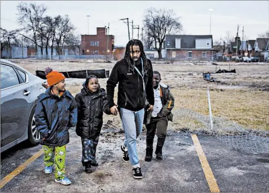  ?? BRIAN CASSELLA/CHICAGO TRIBUNE ?? Friends of the Children mentor Keenan Palmer takes Caleb, 7, from left, Javier, 6, and Willie, 7, to McDonald’s after school on Jan. 2 in North Lawndale.