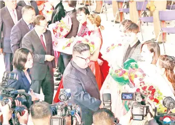  ??  ?? Kim accompanie­d by China’s Culture Minister Luo Shugang (third left) attend a joint performanc­e by the DPRK and Chinese artistes at the Mansudae Art Theatre in Pyongyang, North Korea. — Reuters photo