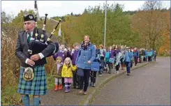  ?? Photograph: Iain Ferguson, alba.photos ?? The pupils are piped from their old school to the new by piper Iain Mitchie.