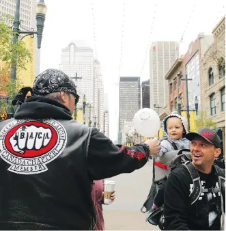  ?? CRYSTAL SCHICK ?? Road Captain, Cowboy, passes out balloons to kids as the Bikers Against Child Abuse arrive at the Telus Convention Centre to kick-start the Internatio­nal Society for Prevention of Child Abuse & Neglect Congress (ISPCAN) 2016 conference on Aug. 27.