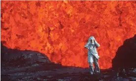  ?? ?? Film still from Fire of Love. Katia Krafft wearing aluminized suit standing near a lava burst at Krafla volcano, Iceland. Photograph: Image'Est