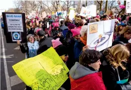  ?? — AP ?? People line up on Central Park West as they wait for the start of a march highlighti­ng equal rights and equality for women Saturday in New York on Saturday. The New York protest was among more than 200 such actions planned for the weekend around the...