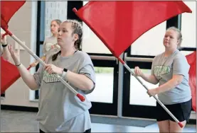  ?? Jeremy stewart ?? Cedartown High School marching band colorguard members Kennedi Newton (left) and Branna Walker practice their routing for the group’s 2021 halftime show during band camp in July.