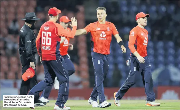  ??  ?? Tom Curran, second right, celebrates after taking the wicket of Sri Lanka’s Dhananjaya de Silva