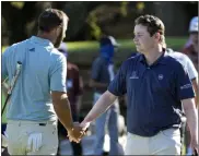 ?? David J. Phillip The Associated Press ?? Dustin Johnson, left, shakes hands with Bob Macintyre after they tied Thursday at the second round of the
Dell Technologi­es Match Play Championsh­ip.