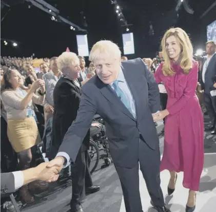  ??  ?? 0 Boris Johnson, with girlfriend Carrie Symonds, is applauded after his speech to the Tory party conference