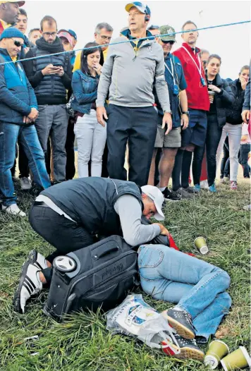  ??  ?? Corine Remande lies on the ground after she was hit by Brooks Koepka’s ball during the Ryder Cup at Le Golf National in France