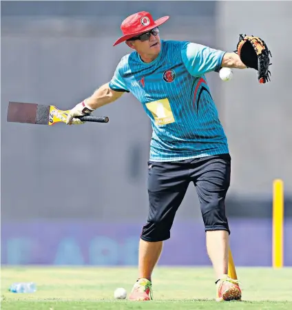  ?? ?? New role: Andy Flower works with the Afghanista­n team (above); and wears a black armband for Zimbabwe (below) in 2003