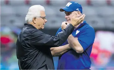  ?? THE CANADIAN PRESS FILES ?? Lions head coach Wally Buono, left, and Winnipeg Blue Bombers offensive coordinato­r and receivers coach Paul LaPolice talk before a pre-season game.