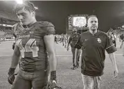  ?? Jerry Larson / Waco Trobune-Herald ?? There was nothing to celebrate for Baylor linebacker Clay Johnston, left, and coach Matt Rhule after the Bears were upset by Liberty on Saturday night.