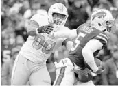  ?? ADRIAN KRAUS/ASSOCIATED PRESS ?? Dolphins rookie DE Charles Harris (90), who has 1 sack in 14 games, chases Bills QB Tyrod Taylor last Sunday.