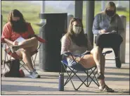  ?? (Arkansas Democrat-Gazette/Staton Breidentha­l) ?? Students Corrinne McClure (from left), Liz Hall and Cassidy Mitchell listen and take notes during Rutherford’s outdoor class.