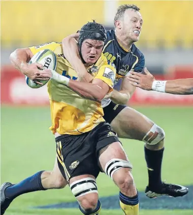  ?? Photos: KENT BLECHYNDEN/FAIRFAX NZ ?? Gotcha: Hurricanes flanker Adam Hill is grabbed around the neck during last night’s match in Wellington.