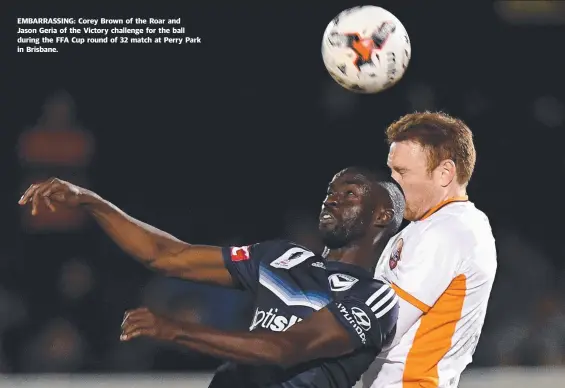  ??  ?? EMBARRASSI­NG: Corey Brown of the Roar and Jason Geria of the Victory challenge for the ball during the FFA Cup round of 32 match at Perry Park in Brisbane.