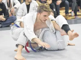  ?? FRAM DINSHAW/TRURO NEWS ?? Marmac Athletics member Connor Mackenzie engaged in an intense, down-to-the-mat contest with Dartmouth’s Ryan Drake.