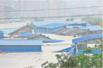  ??  ?? A general view of a flooded street in Loudi, Hunan province. — AFP photo