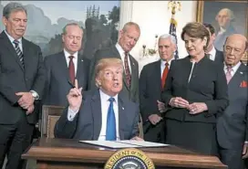  ?? Evan Vucci/Associated Press ?? President Donald Trump speaks Thursday in the White House before signing a presidenti­al memorandum imposing tariffs on China.