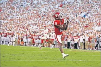  ??  ?? Oklahoma's CeeDee Lamb had little trouble finding open room for a long touchdown reception against Houston in the season opener on Sept. 1. [BRYAN TERRY/ THE OKLAHOMAN]