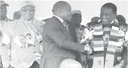  ??  ?? President Mnangagwa congratula­tes Chief Mabhikwa after he received heifers at the launch of the Matabelela­nd North Province Command Livestock and Fisheries Programme at Arda Jotsholo in Lupane on Friday. Looking on is VicePresid­ent Chiwenga (left)