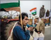  ?? (File Photo/AP/Altaf Qadri) ?? A farmer smokes a bidi, or hand-rolled cigarette, Jan. 7 during a tractor rally to protest new farm laws in Ghaziabad on the outskirts of New Delhi, India.