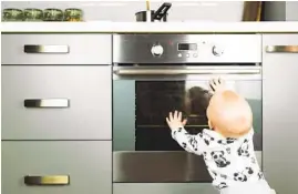  ?? GETTY IMAGES ?? Putting your baby in a high chair while you’re cooking can help prevent them from touching a hot stove.