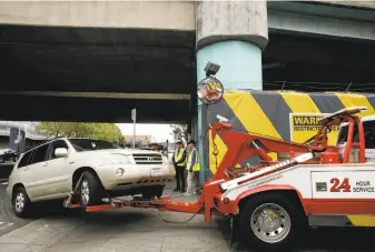  ?? Santiago Mejia / The Chronicle ?? A car enters the San Francisco impound lot. It will cost an average of $557 to get it out.