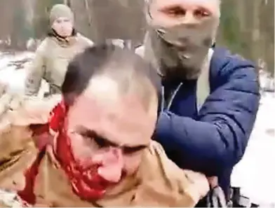  ?? ?? Bloody savagery: A Moscow terror attack suspect being paraded in front of the TV cameras