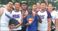  ?? ALPHA DAFFAE SENKPENI / FOR CHINA DAILY ?? Joseph Toumed, a Liberian assistant instructor at a summer camp, takes a group picture with his students outside Peking University in Beijing last month.